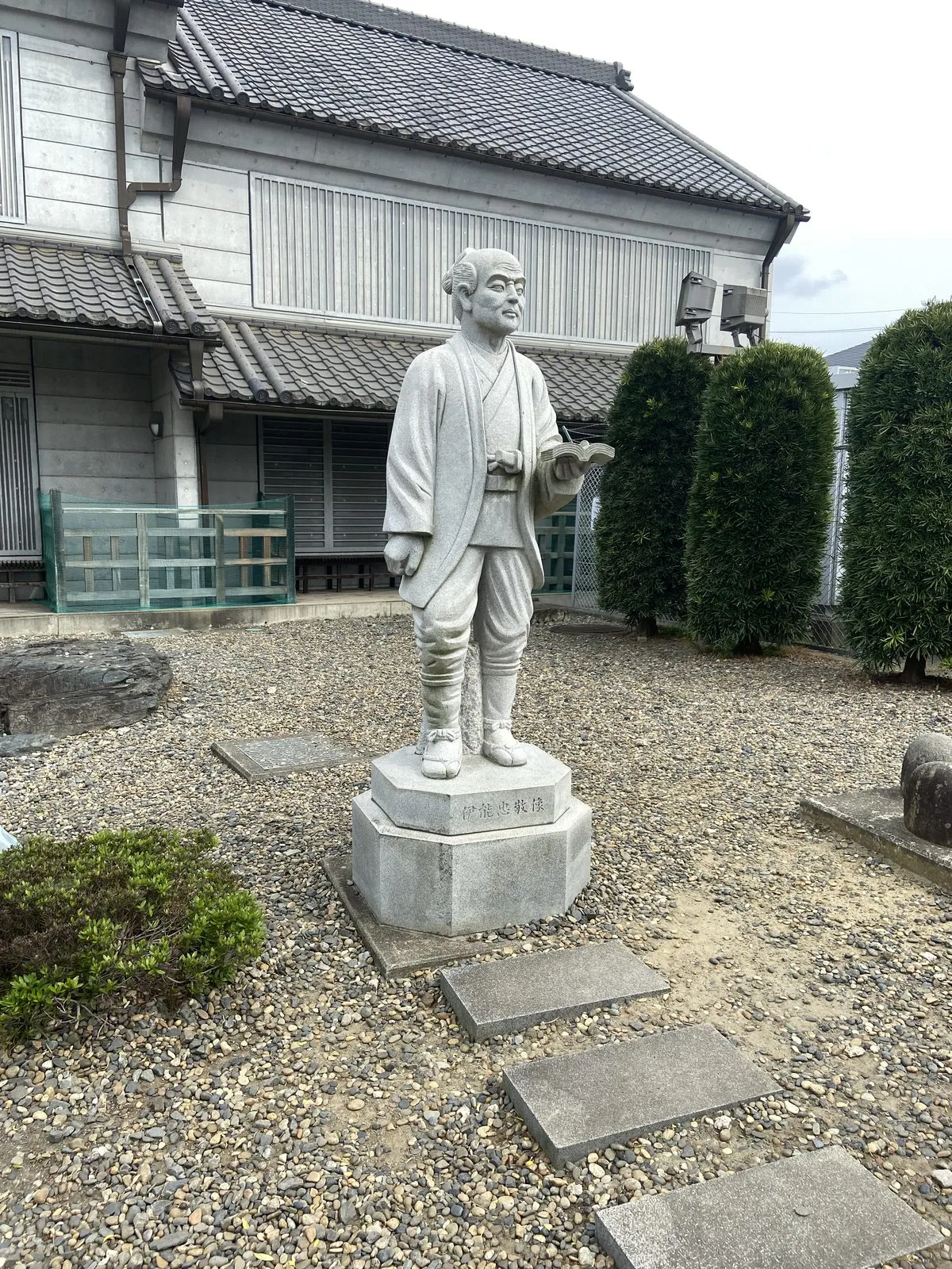 Stone statue of Ino Tadataka holding a survey book in Sawara