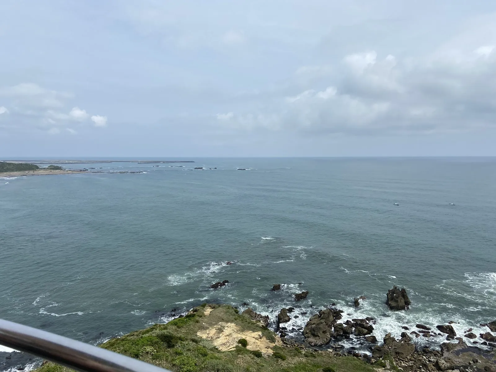 The view from the top of Inubosaki Lighthouse: the Pacific and waves breaking on rocks below