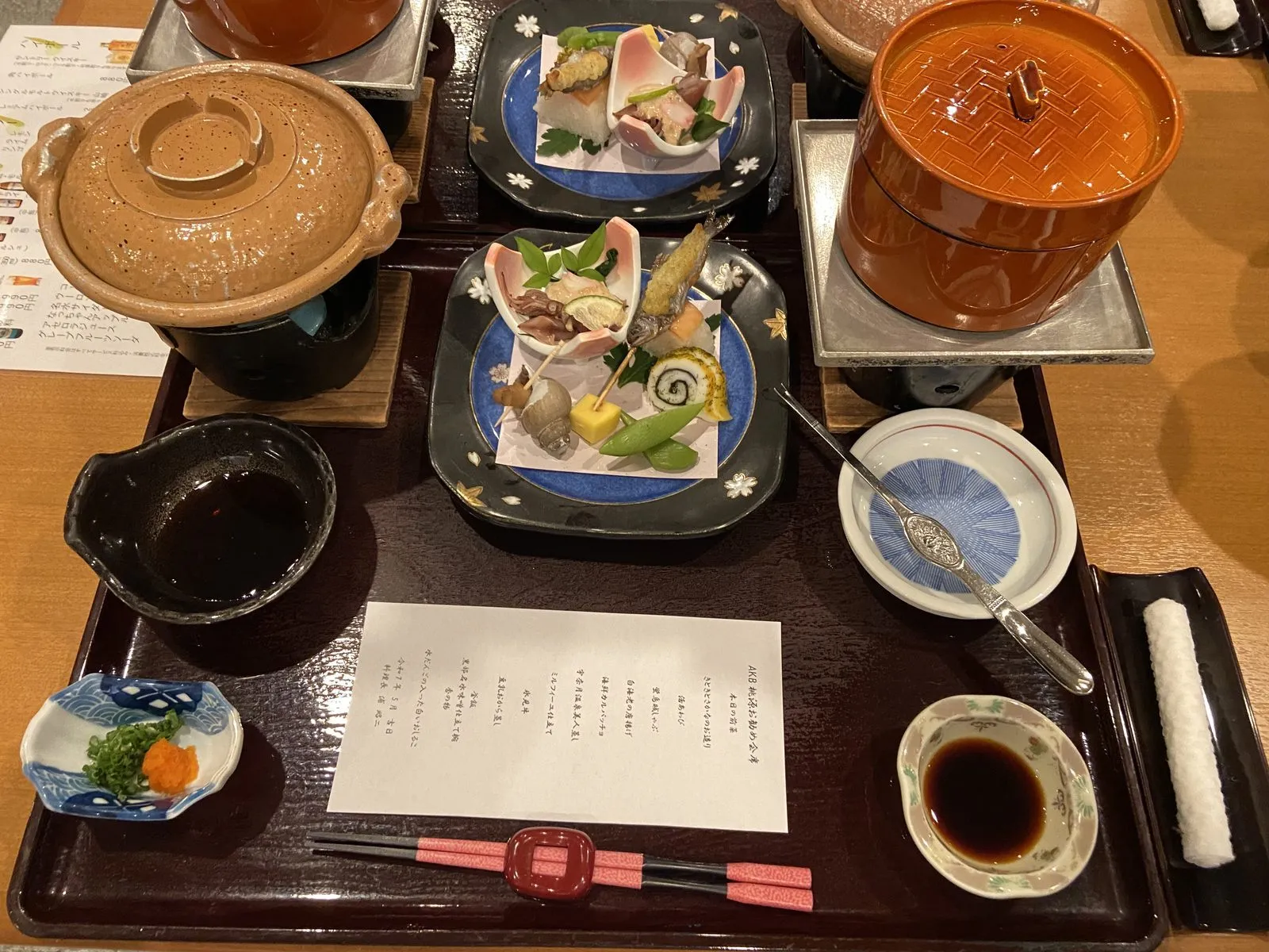 Kaiseki dinner spread at Togen ryokan in Unazuki Onsen with the menu card