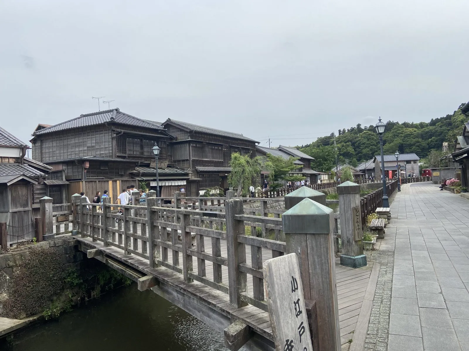 Old wooden merchant houses along the Sawara canal, seen past the Toyohashi bridge