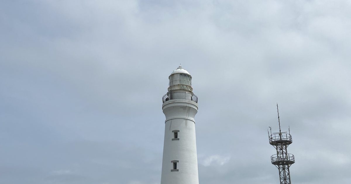 The white Inubosaki Lighthouse against the sky at Choshi